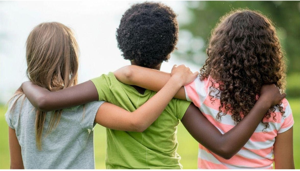 Three children with arms around each other